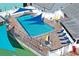 The community pool is surrounded by lounge chairs and shade structures at 6047 Elmhurst Dr # 5A, New Port Richey, FL 34653