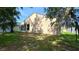 Lush backyard with mature trees, offering a private outdoor space at 6054 Merrifield Dr, Zephyrhills, FL 33541