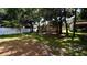 Large backyard with mature trees and a white fence at 6054 Merrifield Dr, Zephyrhills, FL 33541