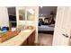 A bathroom features a vanity with a mirror, and access to a bedroom at 6054 Merrifield Dr, Zephyrhills, FL 33541