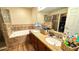 Bathroom featuring double sinks, a shower with a glass door, and a soaking tub at 6054 Merrifield Dr, Zephyrhills, FL 33541