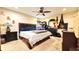 Cozy primary bedroom with ceiling fan, carpeted floors, and generous natural light at 6054 Merrifield Dr, Zephyrhills, FL 33541