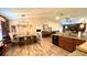 Open-concept dining area featuring modern lighting, wood accents, and a connected kitchen at 6054 Merrifield Dr, Zephyrhills, FL 33541
