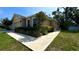 Charming single-story home featuring a well-manicured lawn and lush landscaping enhancing its curb appeal at 6054 Merrifield Dr, Zephyrhills, FL 33541