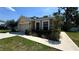 Charming single-story home featuring a two-car garage and nicely landscaped front yard at 6054 Merrifield Dr, Zephyrhills, FL 33541