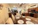 Open-concept living space with dining area, kitchen, and living room with vaulted ceiling at 6054 Merrifield Dr, Zephyrhills, FL 33541
