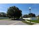 Peaceful neighborhood street featuring mature trees, sidewalks, and well-maintained landscaping, emphasizing a serene environment at 6054 Merrifield Dr, Zephyrhills, FL 33541