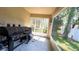 Relaxing outdoor screened patio featuring a grill, a concrete floor, and a view of the yard at 6054 Merrifield Dr, Zephyrhills, FL 33541