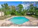 Secluded backyard pool surrounded by mature trees, offering a tranquil and private retreat at 6104 Cork Ct, New Port Richey, FL 34653