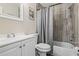 Bright bathroom with a white vanity, modern fixtures, and a shower-tub combination at 6104 Cork Ct, New Port Richey, FL 34653