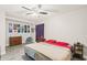 Spacious bedroom with neutral decor, wood-look floors, and a ceiling fan for enhanced comfort at 6104 Cork Ct, New Port Richey, FL 34653