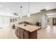 Open-concept kitchen featuring a center island, recessed lighting, and seamless flow to the living area at 6104 Cork Ct, New Port Richey, FL 34653