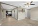 Open-concept living room with wood-look tile flooring leading to a kitchen with dark cabinets at 6104 Cork Ct, New Port Richey, FL 34653