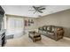 Living room area with a comfortable brown leather sofa and sliding glass door at 6104 Cork Ct, New Port Richey, FL 34653
