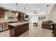 Open kitchen with granite countertops and stainless steel appliances adjoining a spacious living room at 6104 Cork Ct, New Port Richey, FL 34653
