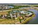 Aerial view of community amenities including tennis courts, clubhouse, pool, and playground near lake at 6229 Sea Air Dr, Apollo Beach, FL 33572