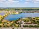 Aerial view featuring a lake, green spaces, a community playground and recreational facilities at 6229 Sea Air Dr, Apollo Beach, FL 33572