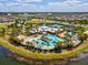 Aerial view of community pool with slide, clubhouse, and numerous Gathering-friendly amenities at 6229 Sea Air Dr, Apollo Beach, FL 33572