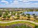 A serene aerial view showcases the community park alongside a beautiful lake, promoting an active and tranquil lifestyle at 6229 Sea Air Dr, Apollo Beach, FL 33572