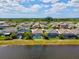 Backyard view features a private screened-in pool overlooking a tranquil lake, complemented by palm trees and lush landscaping at 6229 Sea Air Dr, Apollo Beach, FL 33572
