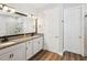 Bright bathroom features double vanity with granite counters and wood-look floors at 6229 Sea Air Dr, Apollo Beach, FL 33572