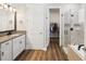 Well-lit bathroom with granite counters, walk-in closet, and glass shower at 6229 Sea Air Dr, Apollo Beach, FL 33572