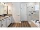 Bathroom with a vanity, granite countertop, glass-enclosed shower, and modern fixtures for a spa-like feel at 6229 Sea Air Dr, Apollo Beach, FL 33572