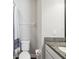 Well-lit bathroom with a shower featuring a blue and white curtain, white toilet, and granite countertop at 6229 Sea Air Dr, Apollo Beach, FL 33572