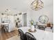 Open dining area connected to the kitchen with a white dining table, decor, and black modern chairs at 6229 Sea Air Dr, Apollo Beach, FL 33572