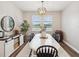 Dining room with stylish chandelier, decor, bright windows with views, and a rustic-modern aesthetic at 6229 Sea Air Dr, Apollo Beach, FL 33572