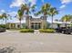 Community clubhouse exterior with a stone facade, palm trees, and ample parking offers a welcoming entrance at 6229 Sea Air Dr, Apollo Beach, FL 33572