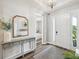 Welcoming foyer with hardwood floors, stylish console table, and natural light at 6229 Sea Air Dr, Apollo Beach, FL 33572