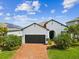 Charming single-Gathering home with a brick driveway, lush landscaping, and a two-car garage at 6229 Sea Air Dr, Apollo Beach, FL 33572