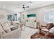 Inviting living room with ample seating, a decorative fireplace, and large sliding doors to the outdoor area at 6229 Sea Air Dr, Apollo Beach, FL 33572