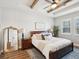 Cozy main bedroom featuring a wooden ceiling beam, dark wood furniture, a ceiling fan, and a serene atmosphere at 6229 Sea Air Dr, Apollo Beach, FL 33572