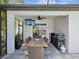 Covered outdoor dining area with TV and grill, ideal for entertaining and enjoying the Florida weather at 6229 Sea Air Dr, Apollo Beach, FL 33572