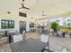 Inviting covered outdoor seating area with fan-cooled tables and chairs, perfect for relaxing by the pool at 6229 Sea Air Dr, Apollo Beach, FL 33572