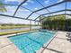 Backyard pool with spa and sun-shelf inside screened enclosure at 6229 Sea Air Dr, Apollo Beach, FL 33572