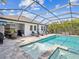 Sparkling pool with integrated spa, lounge chairs and outdoor dining for relaxing and entertaining at 6229 Sea Air Dr, Apollo Beach, FL 33572