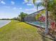 Backyard pool with screened enclosure and manicured landscaping at 6229 Sea Air Dr, Apollo Beach, FL 33572