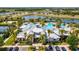 Resort-style pool area featuring a clubhouse, splash pad, and ample seating with lush tropical landscaping at 6229 Sea Air Dr, Apollo Beach, FL 33572