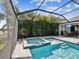 Screened pool and spa area with mature landscaping offering privacy and a peaceful retreat at 6229 Sea Air Dr, Apollo Beach, FL 33572