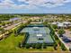 Aerial view of community tennis courts, parking, landscaping, and other recreational facilities at 6229 Sea Air Dr, Apollo Beach, FL 33572