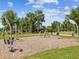 Outdoor workout park featuring stationary exercise equipment, set amidst trees and grassy areas at 6229 Sea Air Dr, Apollo Beach, FL 33572