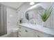 Clean, bright bathroom with a modern vanity, large mirror, and shower-tub combination at 6246 Arthur Ave, New Port Richey, FL 34653