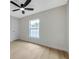 Bright bedroom features a large window for natural light and a modern ceiling fan at 6246 Arthur Ave, New Port Richey, FL 34653