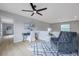 A comfortable loft features an arm chair, desk, and stylish rug, illuminated by a modern ceiling fan at 6246 Arthur Ave, New Port Richey, FL 34653
