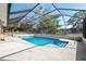 Screened-in pool area with refreshing blue pool water and a spacious concrete deck at 6340 Hillview Rd, Spring Hill, FL 34606