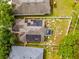 Aerial view of a home with solar panels on the roof and a fenced backyard at 635 Painted Leaf Dr, Brooksville, FL 34604