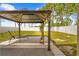 Serene backyard featuring a stylish gazebo, a seating area and a well-maintained white fence offering privacy at 635 Painted Leaf Dr, Brooksville, FL 34604